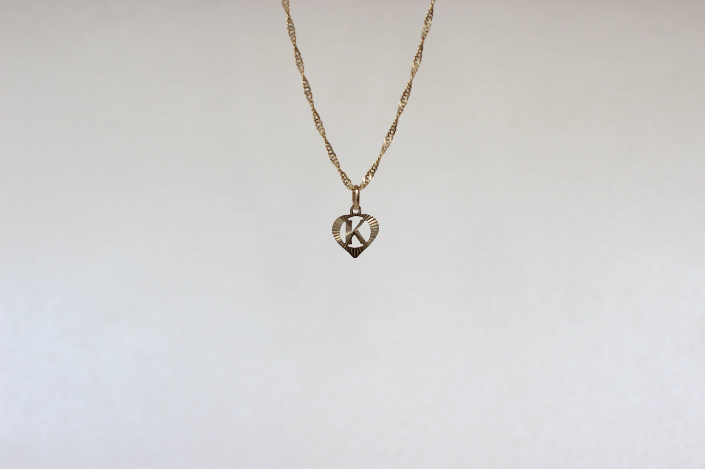 9k Yellow Gold Pendant – Letter "K" in a Heart – Reflective Finish