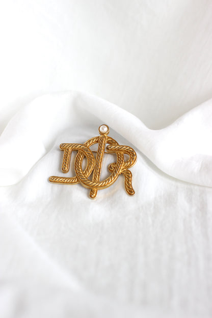 Broche symbole tressée en corde de bateau Dior des années 1980