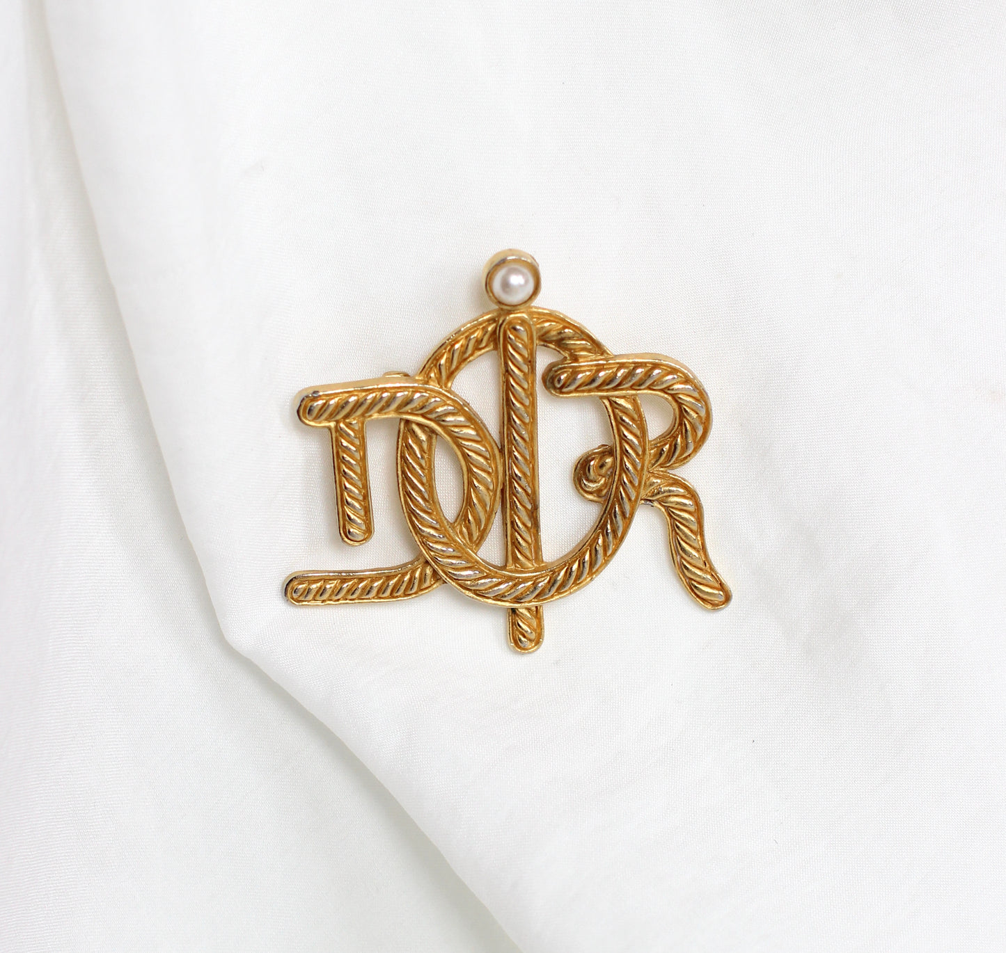 Broche symbole tressée en corde de bateau Dior des années 1980