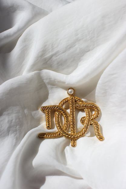 Broche symbole tressée en corde de bateau Dior des années 1980