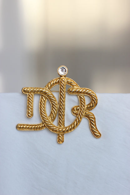 Broche symbole tressée en corde de bateau Dior des années 1980